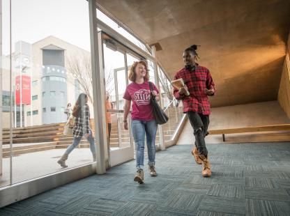 Male and female student walking in a hallway